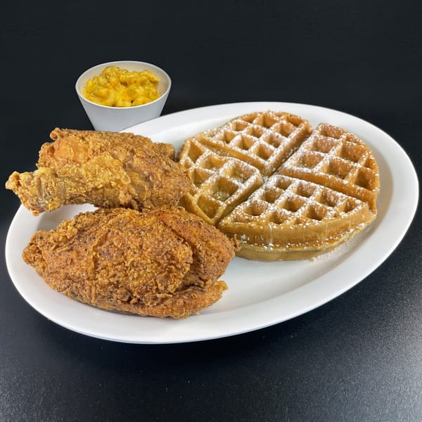Keith’s Chicken N Waffles meal with two pieces of fried chicken, two waffles, and mac and cheese.